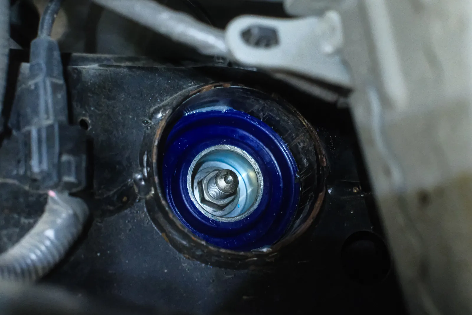 Blue polyurethane rear diff bush fitted to a 370Z
