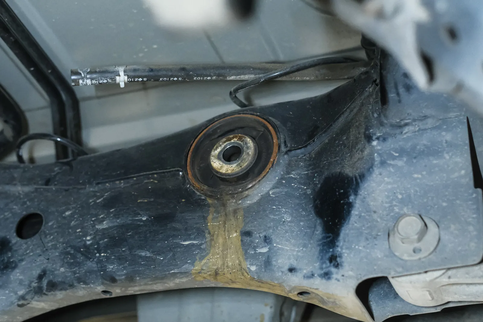 Worn factory 370Z rear diff bush, cracked and weeping gear oil