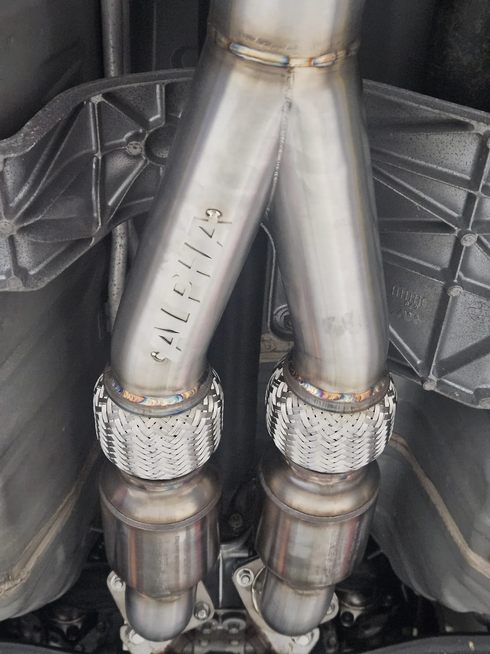 AMS Alpha midpipes with flex joints installed under the R35 GT-R