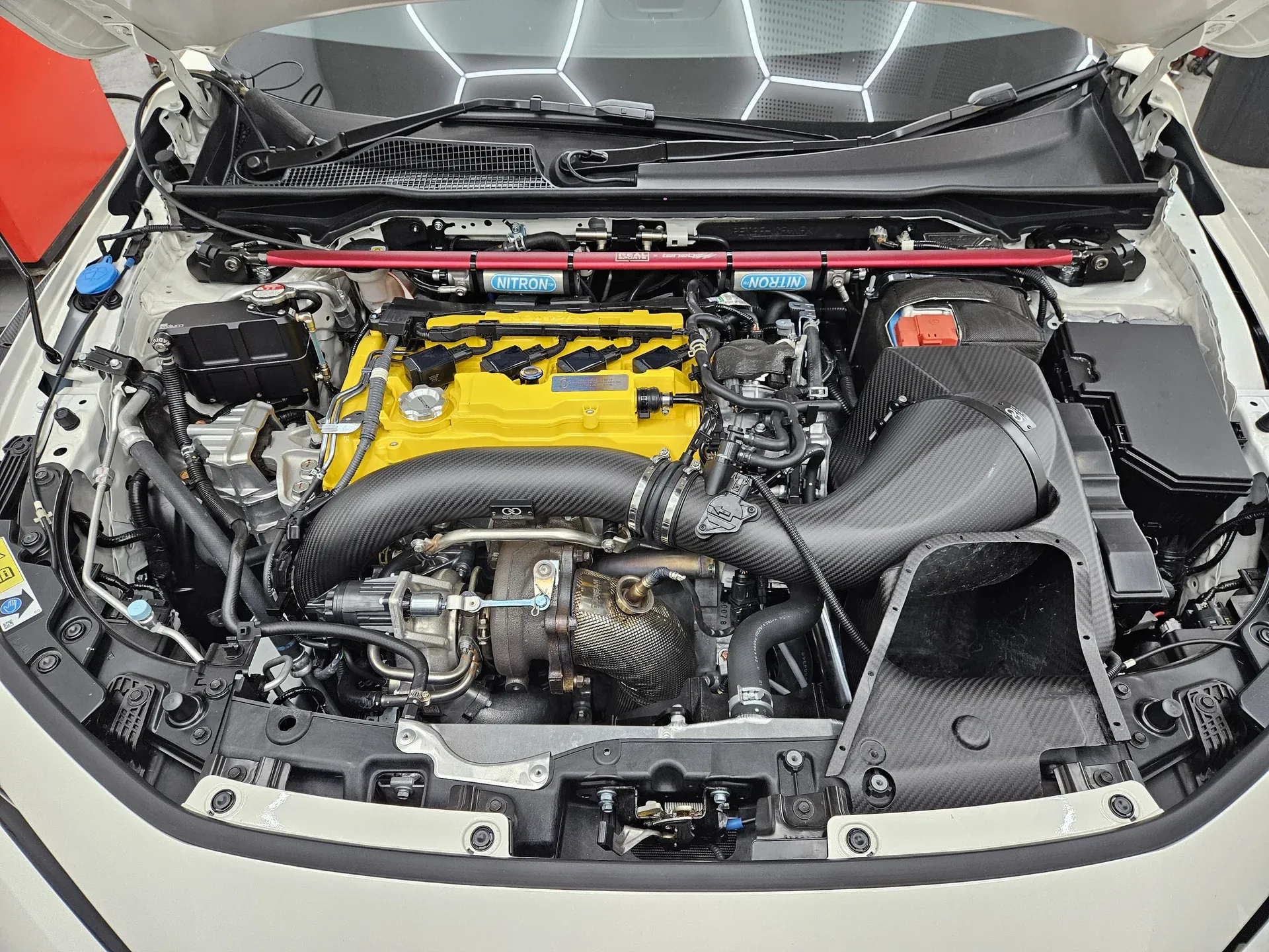 Civic Type R FL5 engine bay with carbon intake and turbo inlet tube over the K20C1