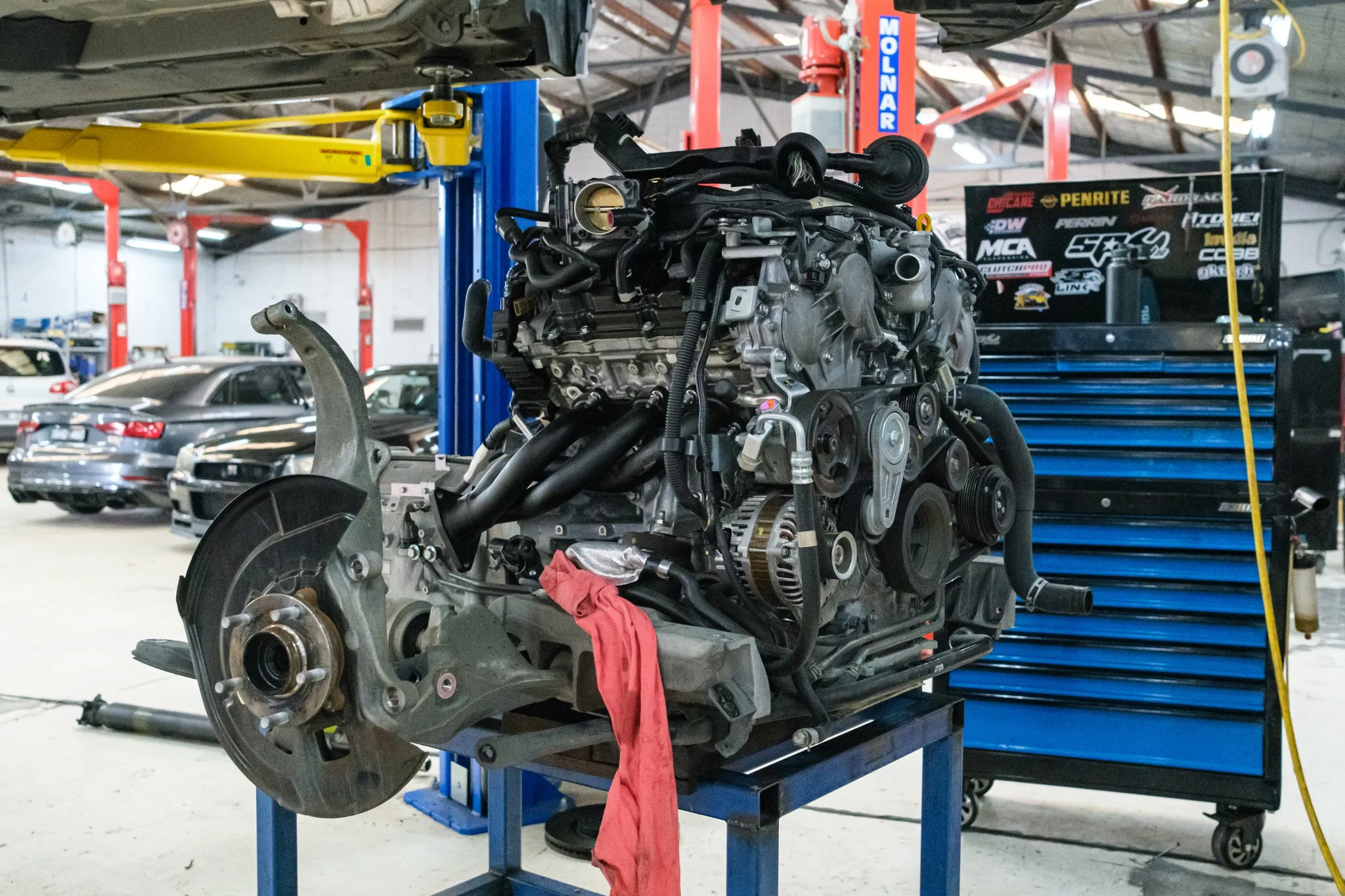 VQ37VHR on the engine stand after removal, with the front subframe still attached