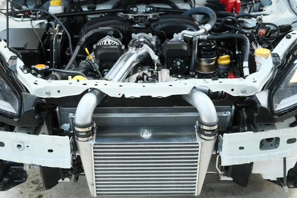 HKS front-mount intercooler and charge piping installed on Subaru BRZ ZD8 with bumper removed