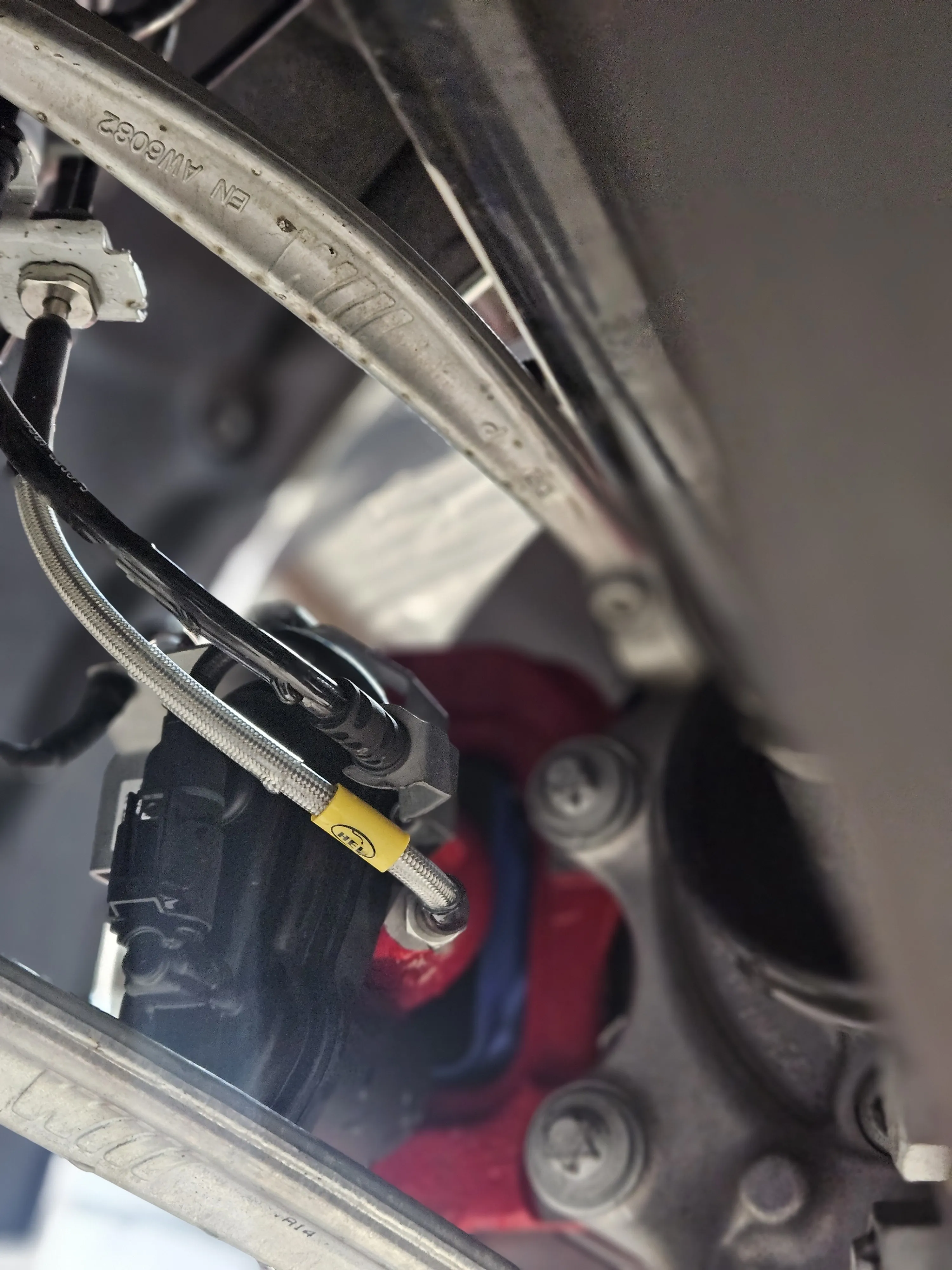 HEL braided brake line installed at caliper on BMW G87 M2