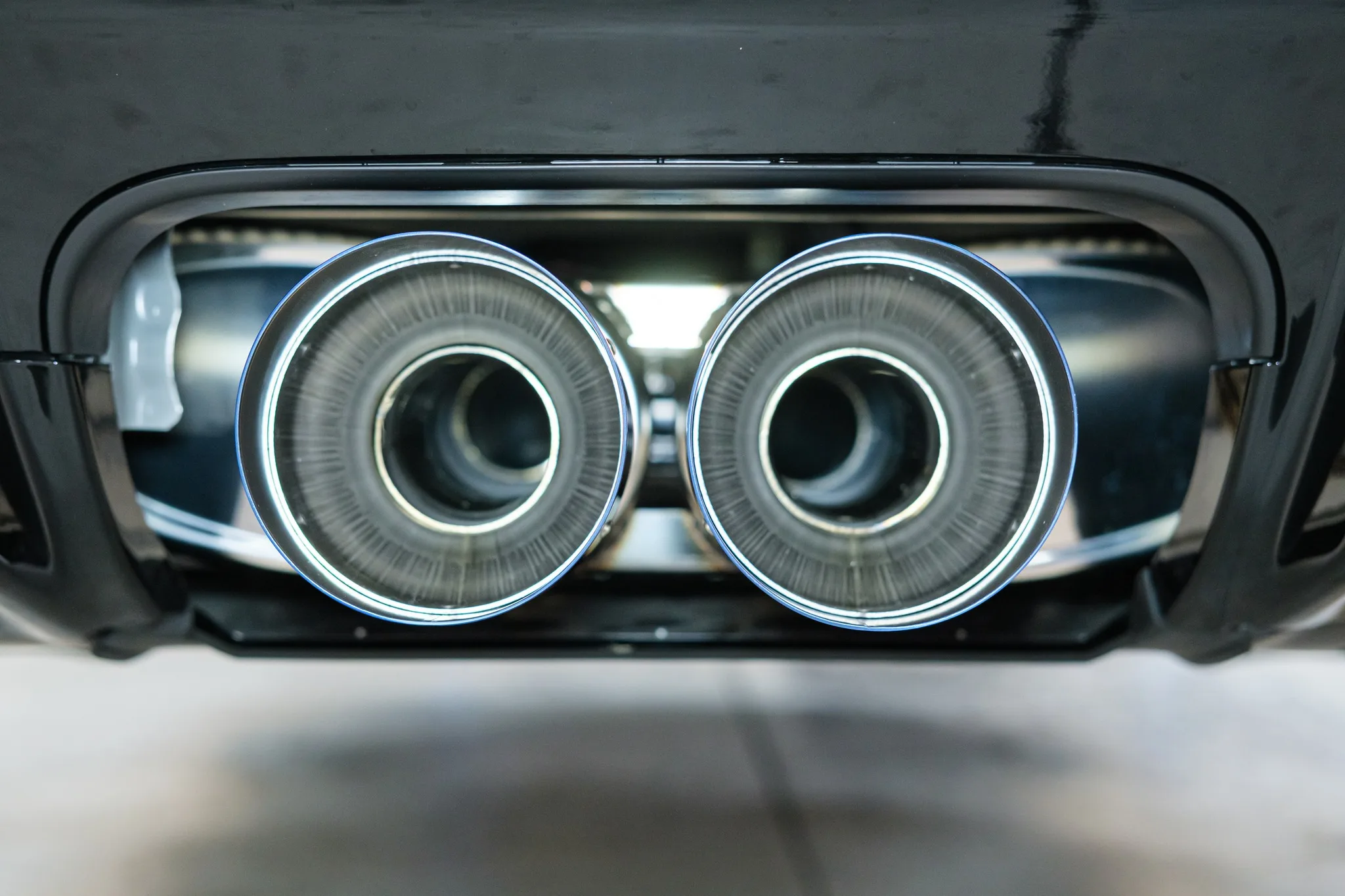 HKS Legamax titanium exhaust tips macro detail showing burnt blue finish