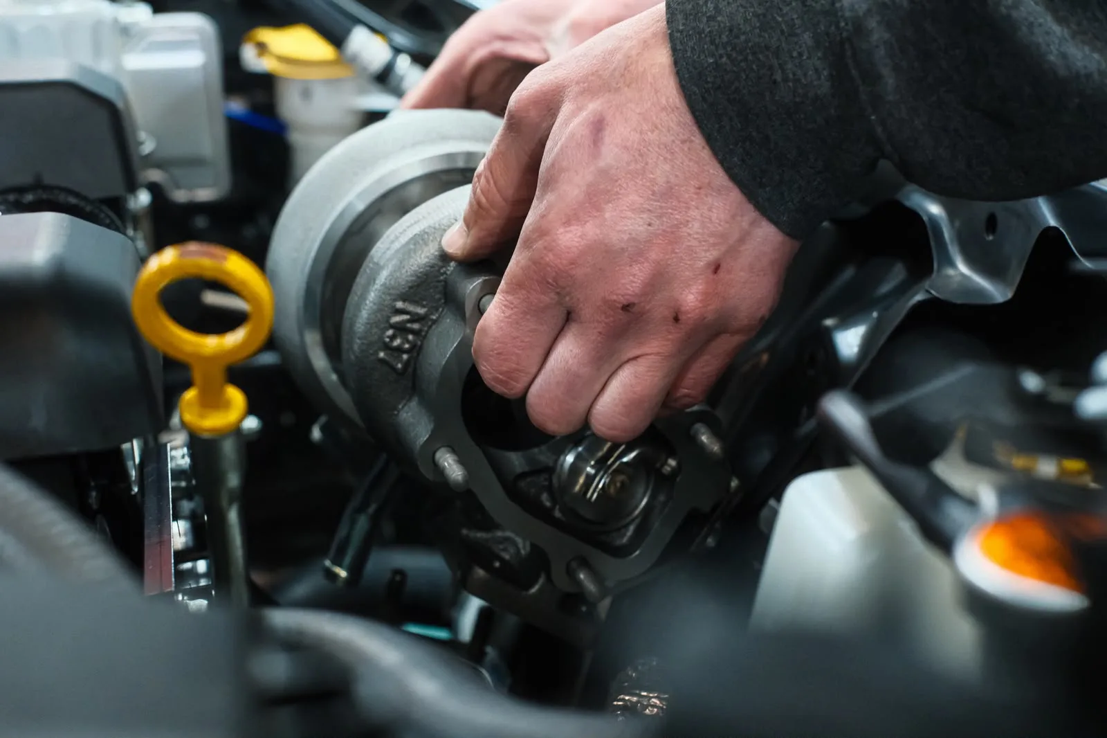 Revzone technician fitting the HKS GTIII-RS turbocharger into the GR86 engine bay