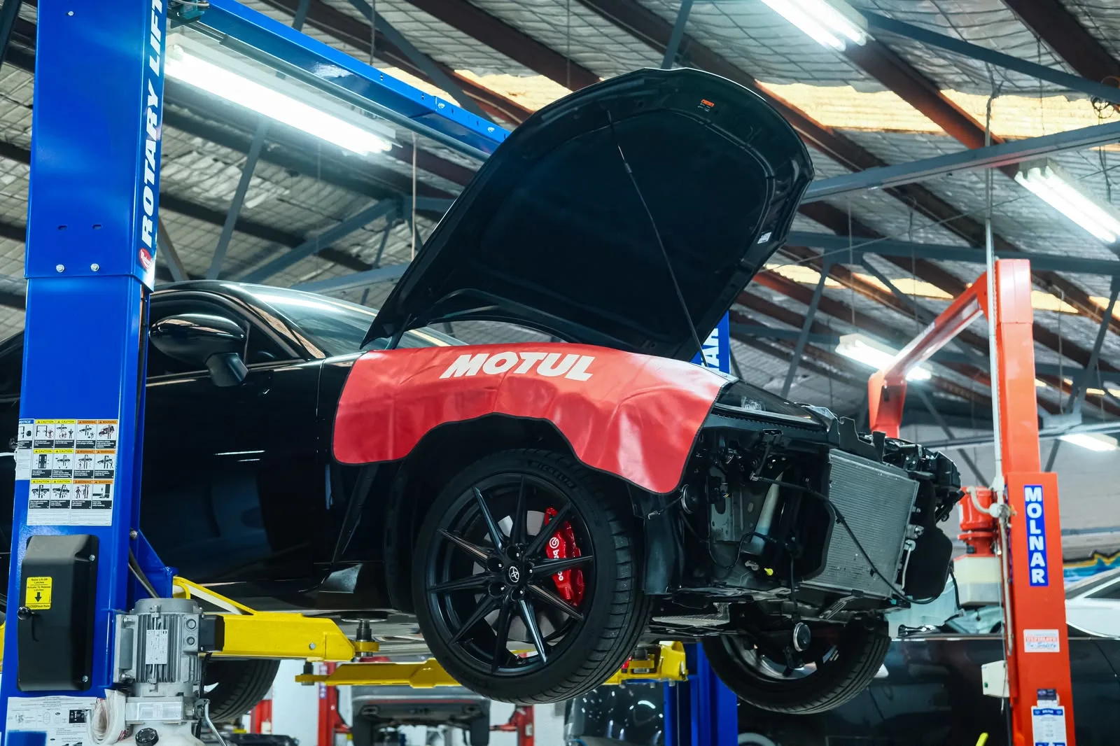Toyota GR86 ZN8 on the hoist with front bumper removed during HKS turbo kit install
