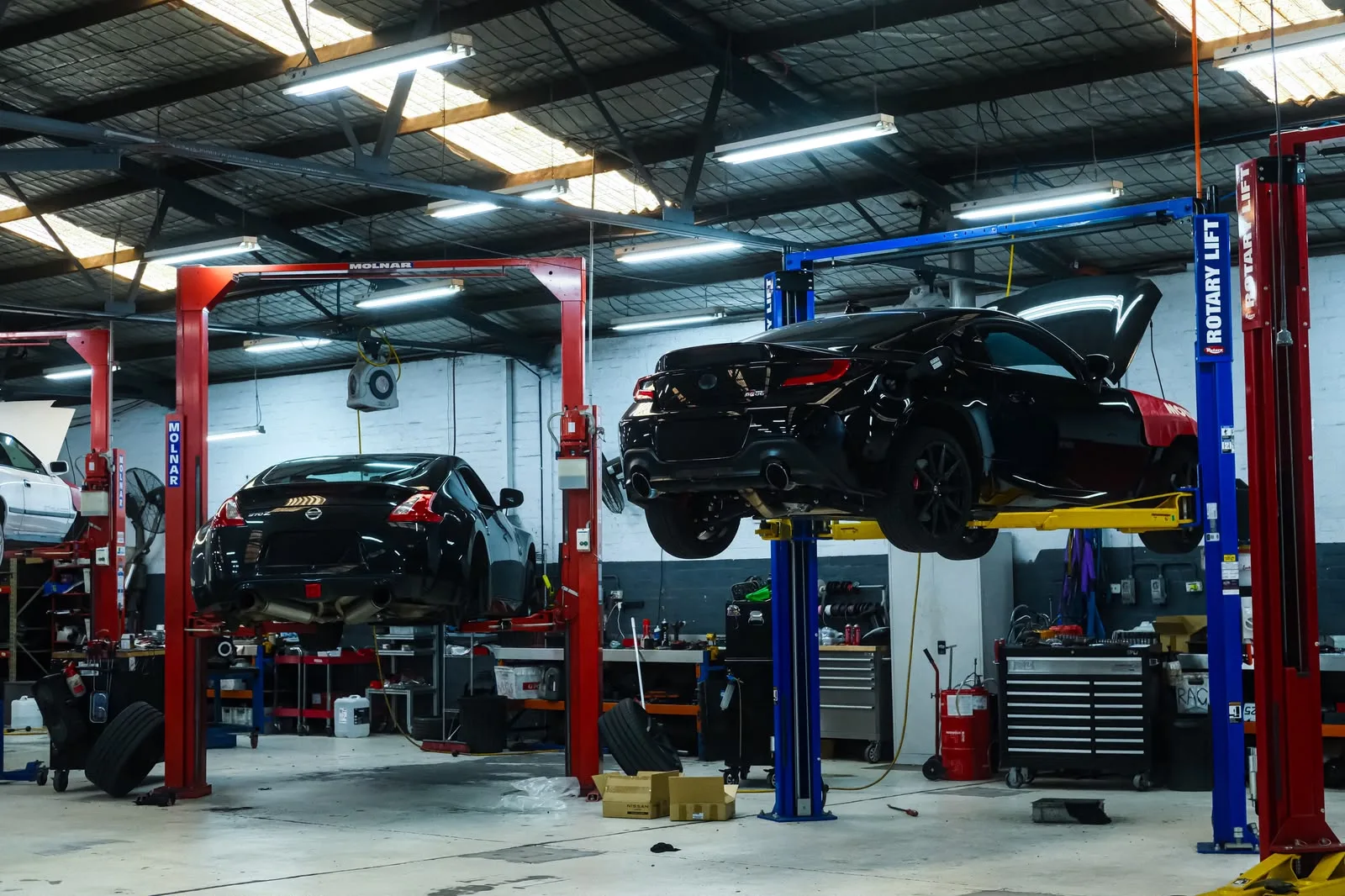 Black Toyota GR86 on the hoist in the Revzone workshop