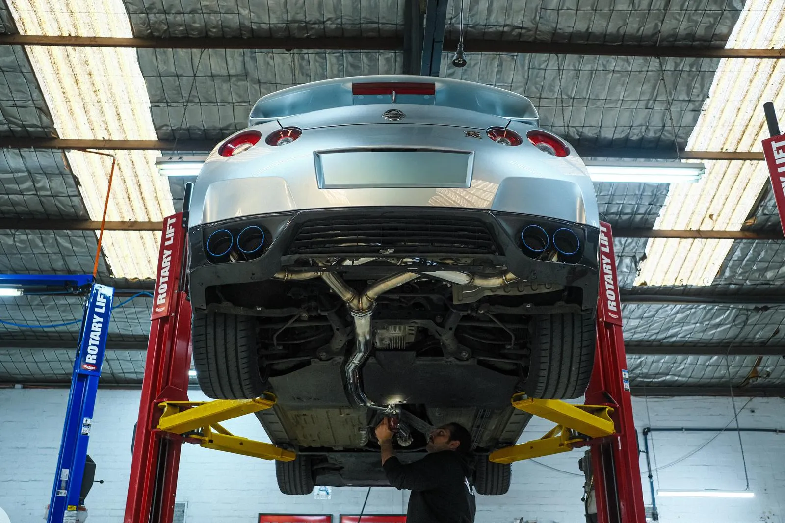 Underside view of R35 GT-R on the hoist with full HKS Legamax Premium catback fitted