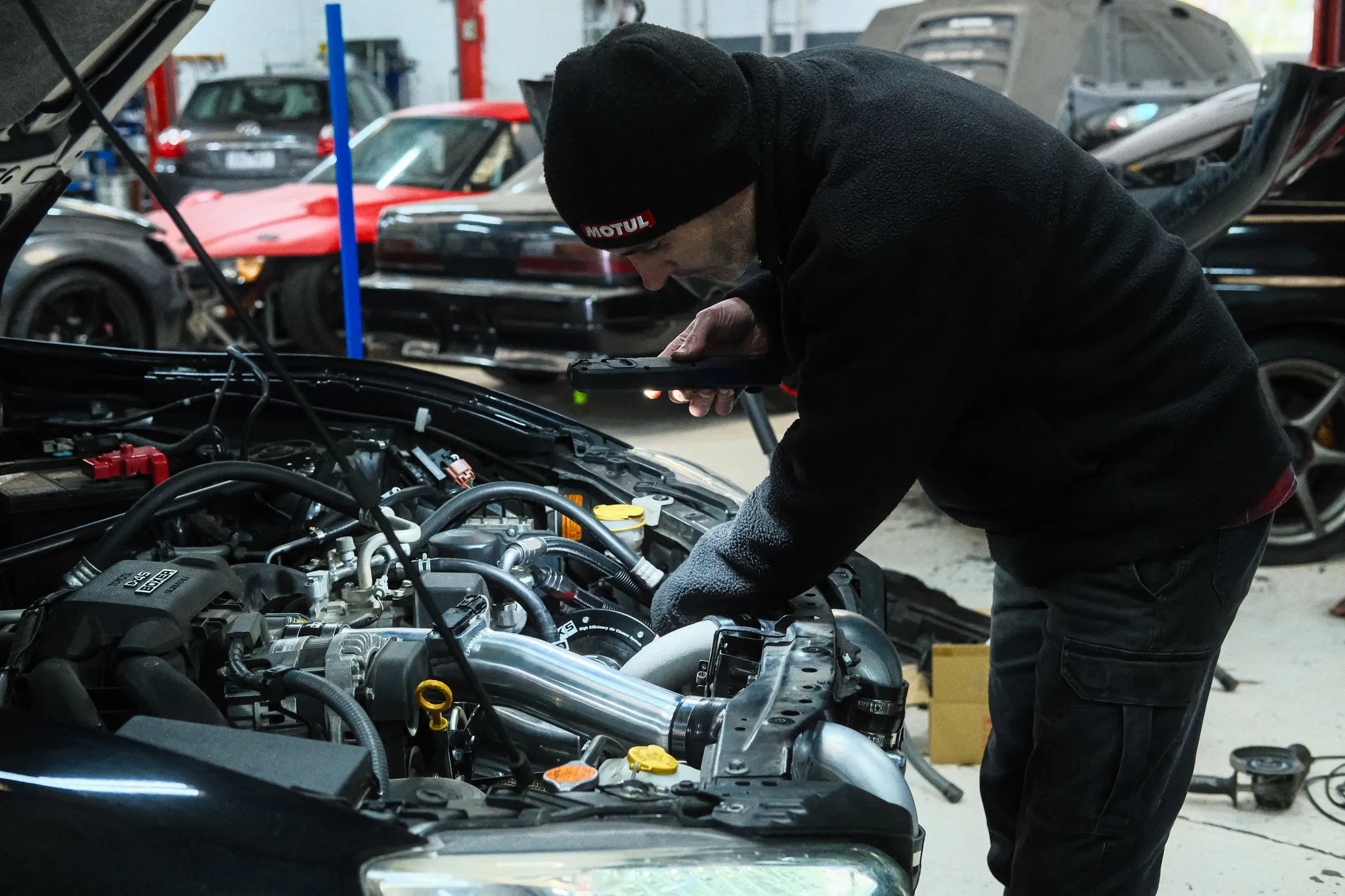 Engine bay detail showing HKS intercooler piping and blow-off valve