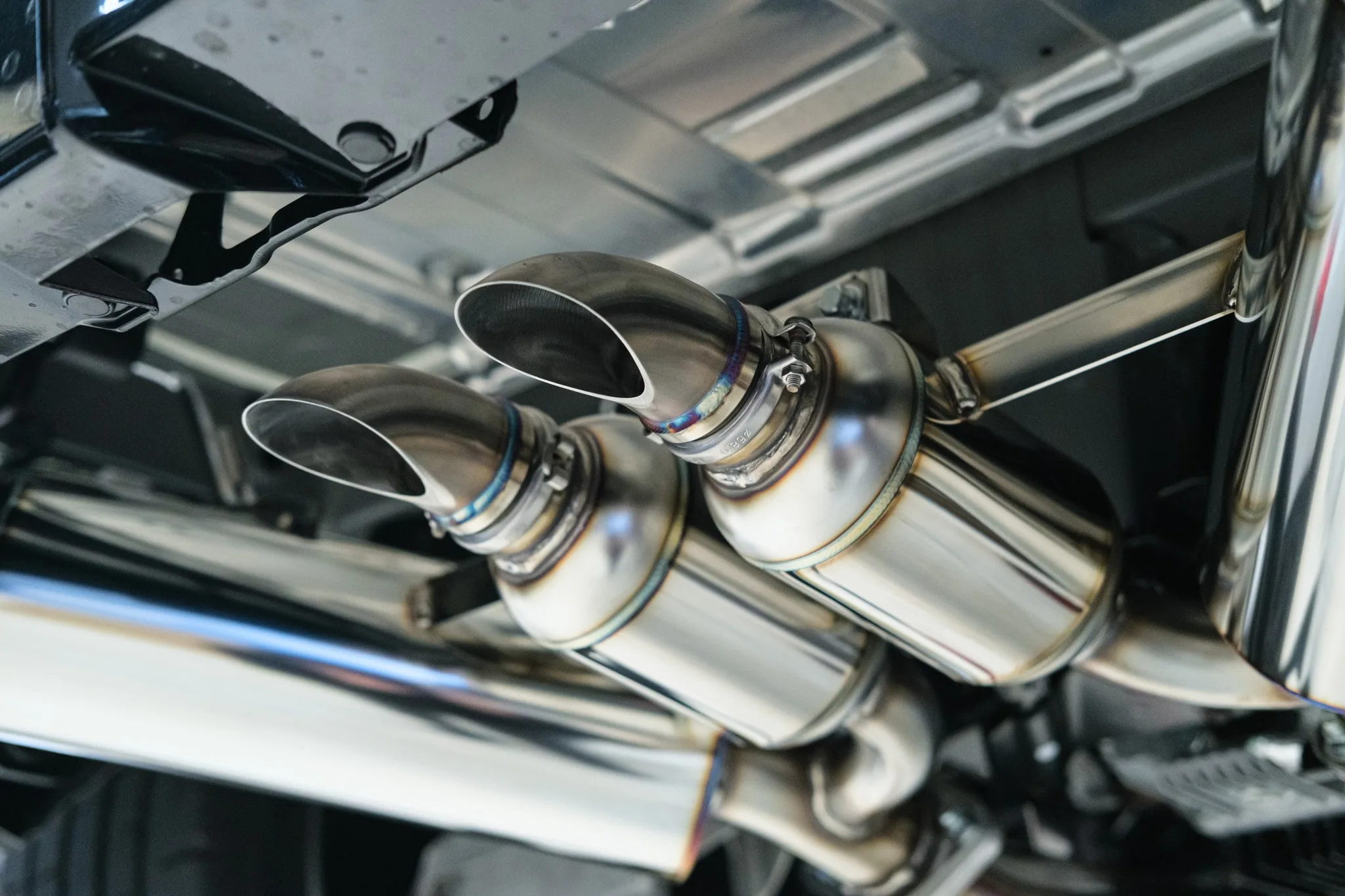 HKS dual muffler tips close-up on Nissan Z NISMO showing polished finish