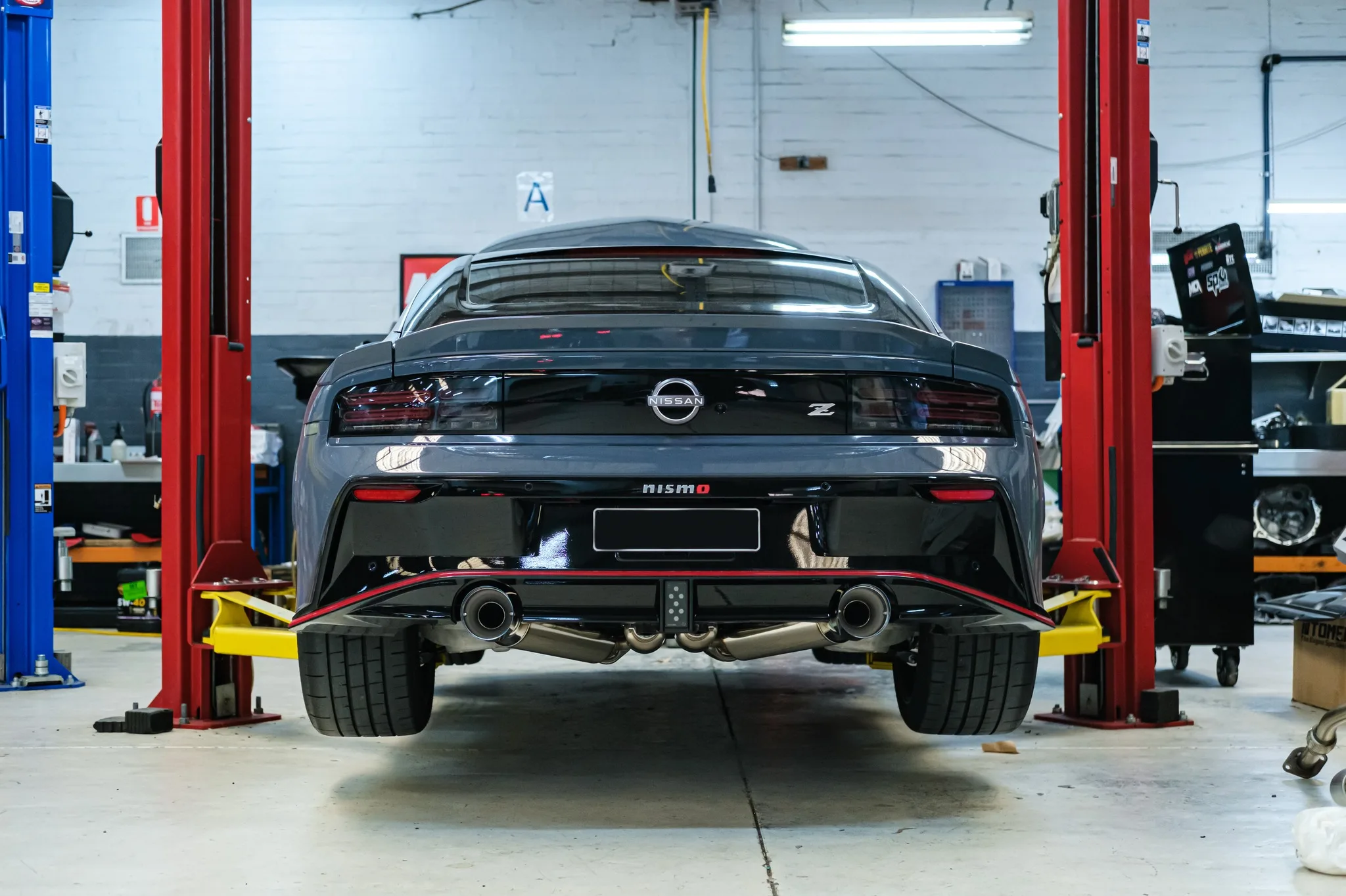 Nissan Z NISMO rear view with HKS catback exhaust tips visible through diffuser