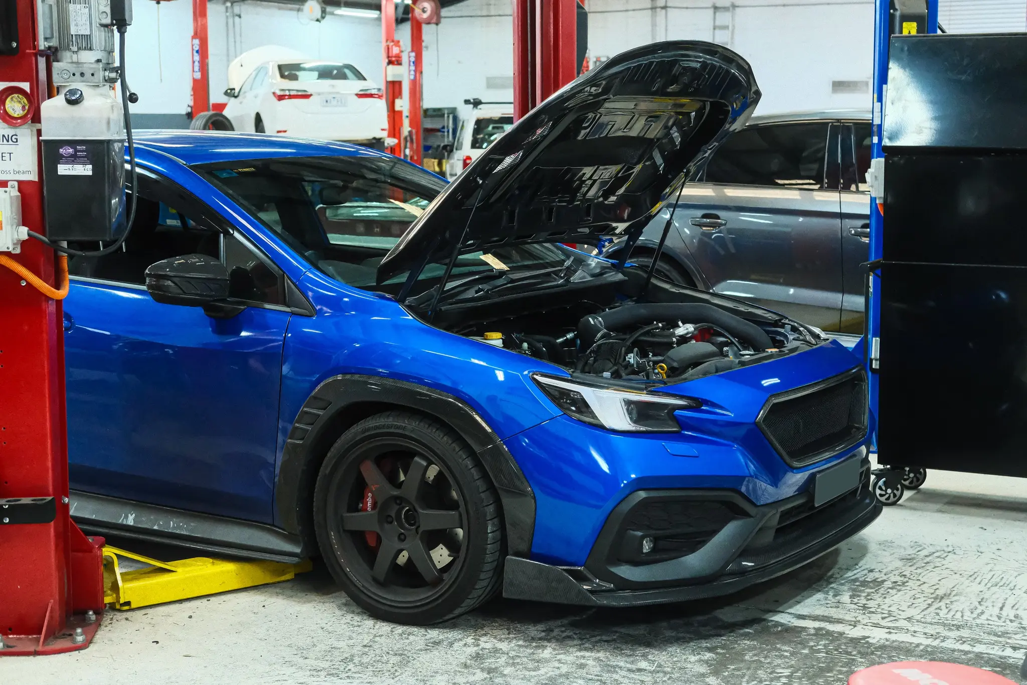 Blue WRX VB with hood open on the Dynapack at Revzone Melbourne