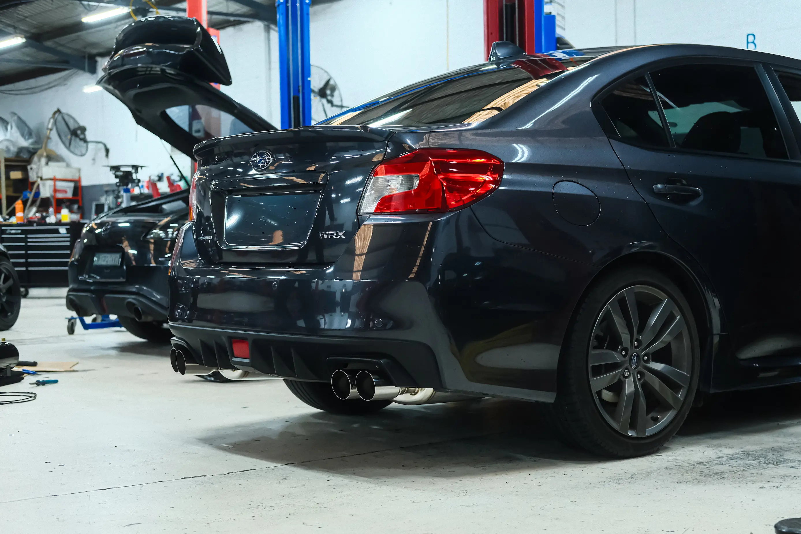 HKS Legamax exhaust pipework under a Subaru WRX VA